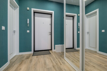 long empty corridor in interior of entrance hall of modern apartments, office or clinic with many doors