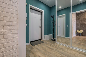 long empty corridor in interior of entrance hall of modern apartments, office or clinic with many doors