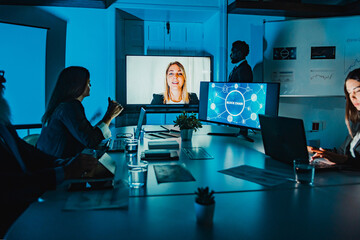 Team work watching video call from blockchain advisor inside hedge fund office - Focus on woman on screen
