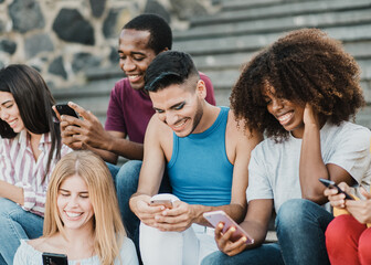Diverse young people having fun using smartphones app outdoor at college - Focus on gay man