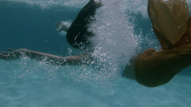 Woman falls back into swimming pool
