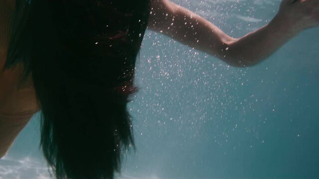Young woman falls inert in swimming pool