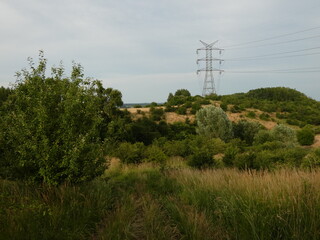 Rural landscape with electricity pylon on the hill, Gdansk, Poland