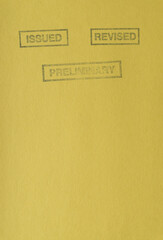 the words issued, revised, and preliminary stamped on yellow paper