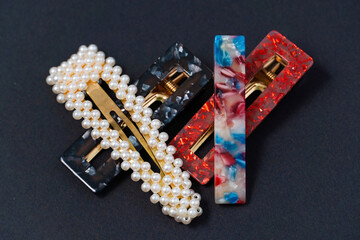 hair clips of different colours and different styles on a dark background