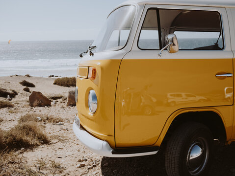 Vintage Yellow Mustard Camper Van Parked with Stunning Beach Views - Powered by Adobe