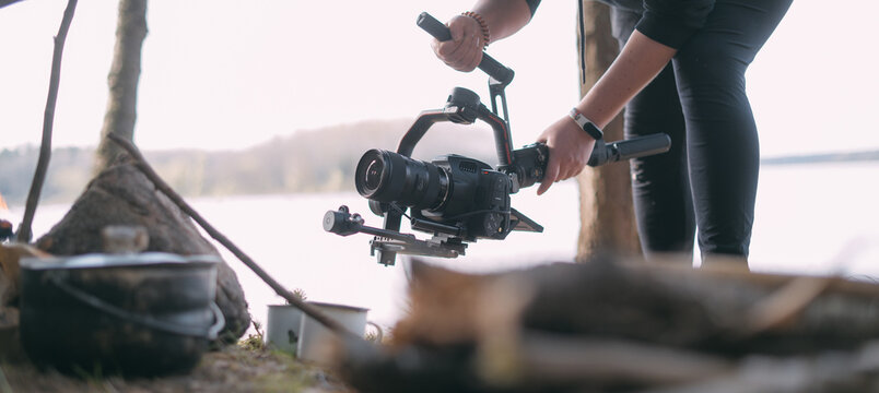 Shooting a video clip, vlog in nature. Close-up of a professional camera. Camera on the stabilizer in female hands