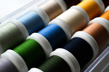 Tailoring concept. Closeup of reels of colorful threads for sewing machine. Tools for sewing