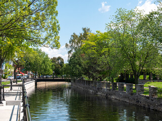Lachine canal water scenic view of environmental friendly suburbia rich in green trees. Lachine,...