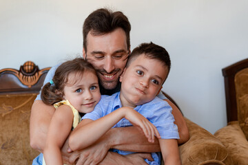 Uncle happily spends time with his nephews, hugs the girl and the boy, he is happy to meet after a...