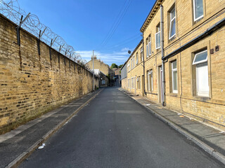View along, Fearnside Street, with sandstone walls, and cottages, in the post industrial city of, Bradford, Yorkshire, UK