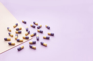 Medical pills on pastel background. Сoncept of taking medications. Copy space. Selective focus.