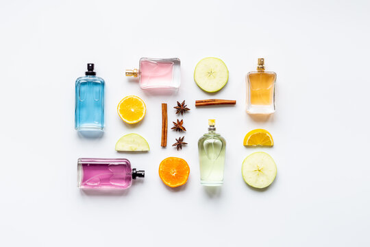 Set of perfume bottles with fragrance spaces and fruits