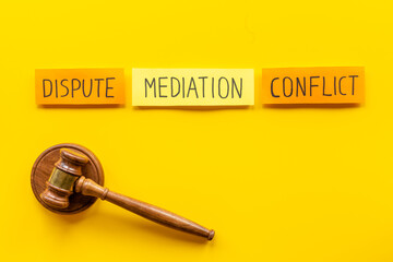 Word mediation on office table between conflict and dispute. Top view