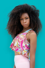 Young afro hairstyle woman on aquamarine blue background