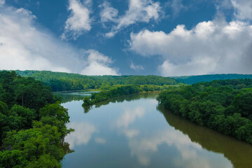 a stunning aerial shot of the still brown waters of the Chattahoochee river surrounded by vast...