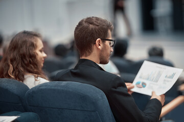 young business people sitting in the conference hall .