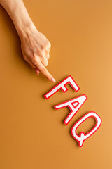 Hands with faq - frequently asked questions - made of paper