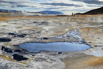 Walking through the smoking fumaroles and boiling mud pots of Namafjall Hverir Geothermal Area, Iceland