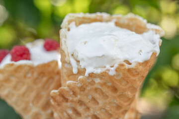 Handmade ice cream in a waffle cone on a hot summer day