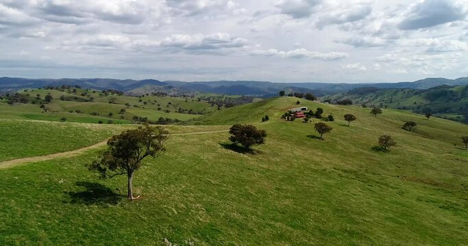 Hillsides to remote farm house in rural Australian country &ndash; aerial 4k.
