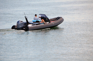 Fototapeta na wymiar Pontoon motorboat powered bay a single outboard engine.
