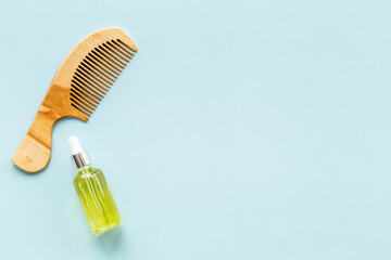 Essential oil for hair care with wooden hair comb