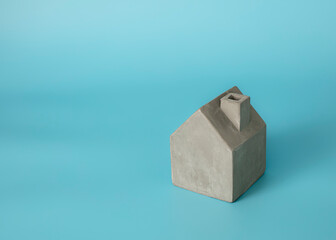 little cement house isolate on blue background 