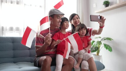 indonesian asian family making selfie and video call using their phone at home