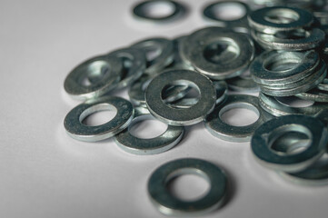 A scattering of metal washers for bolts and screws.