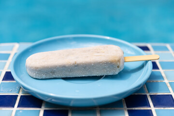 fresh green bean popsicle on the edge of a swimming pool