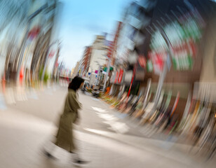 Blurred photo of a woman walking along a shopping street in Tokyo