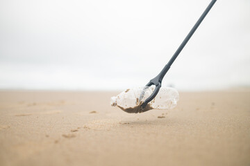 Garbage collection on the ocean. Paper, cardboard, plastic, food waste are scattered on the shore. Environmental protection. Purification of debris and toxins of wildlife.
