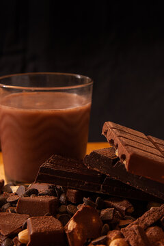 Chocolate bars and milkshake on a black background