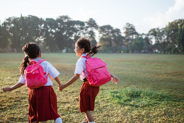 two girl friend primary school student walking together
