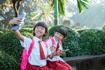 best friend of indonesian primary school student take selfie