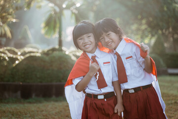 indonesian school student holding flag during independence day.