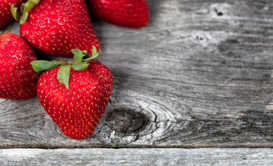 Close up of fresh strawberry fruit on rustic wood