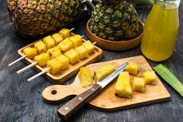fresh pineapple sliced on a wooden board.