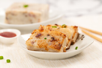 Pan fried chinese radish cake, turnip cake or daikon cake ready to be served