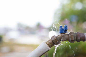 Exterior leaking water faucet or tap in yard