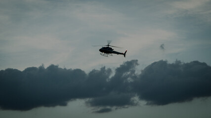 Fototapeta na wymiar helicopter overflight during the afternoon on a cloudy day