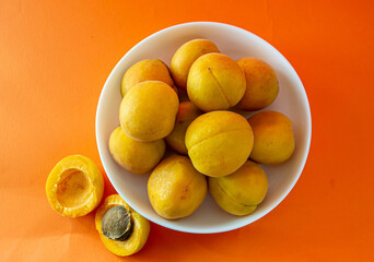 Apricot. Ripe organic apricots on an orange background. Ukraine july 2021