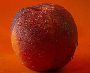 Peach, fresh peach on orange background, peach on which water falls
