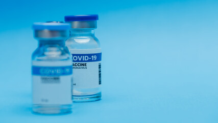 Glass bottles of covid-19 vaccine contains 10 milliliters each dose prepared at clinic before injecting volunteer as immunity activation for people to prevent pathogen outbreak.