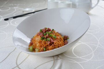 egg fried rice with black truffle, meat and seafood in dark sauce in white background asian halal vegan menu