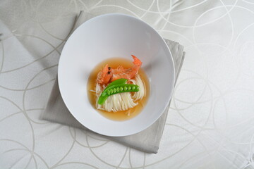 braised handmade thin noodle udon ramen with prawn and vegetable in premium stock soup in white background asian halal vegan menu