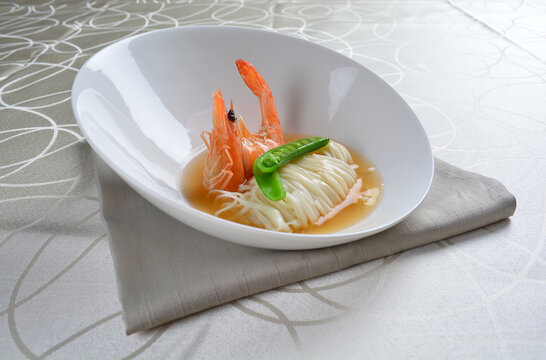 braised handmade thin noodle udon ramen with prawn and vegetable in premium stock soup in white background asian halal vegan menu