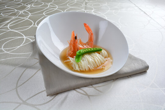 braised handmade thin noodle udon ramen with prawn and vegetable in premium stock soup in white background asian halal vegan menu