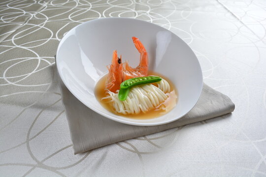 braised handmade thin noodle udon ramen with prawn and vegetable in premium stock soup in white background asian halal vegan menu